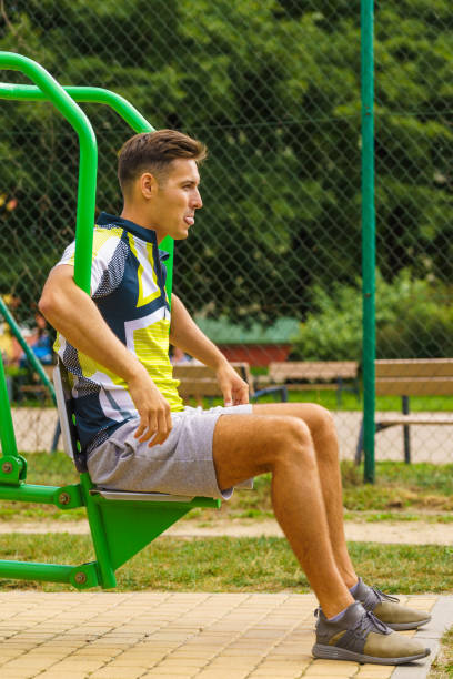 istock Man flexing arm in outdoor gym 1409832854