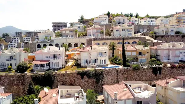 Photo of Buildings and landscape located on slopes of mount. Stock footage. Top view of stepped placement of buildings and cottages of city on mountainside. Mountain resort town