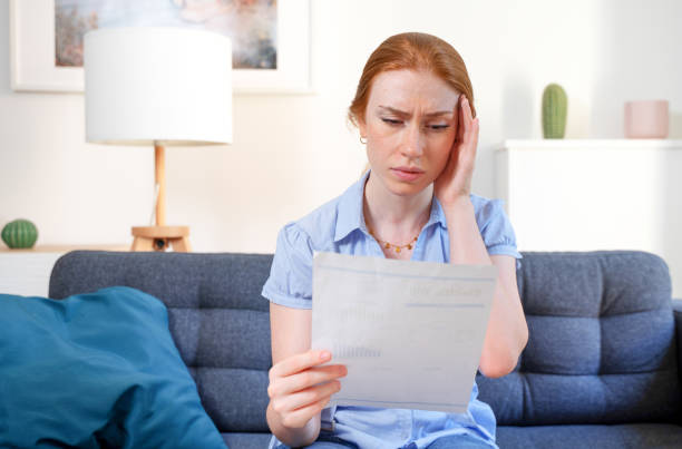 istock Sad woman checking bank statement in financial troubles 1409833847