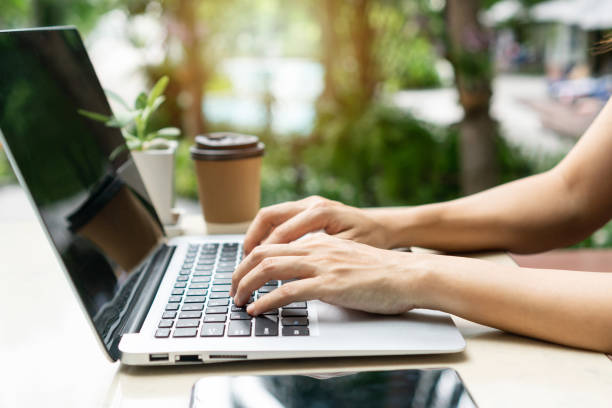 istock Woman hands freelancer is working on laptop computer. Work from home, business and technology concept. Closeup 1409836574