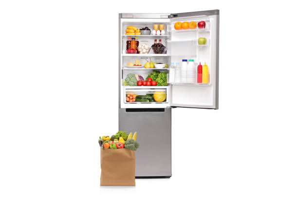 istock Grocery bag with next to an open fridge 1409838089
