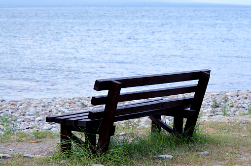 An empty bench looking out to the beautiful coastline of Northumberland and the North Sea