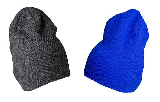 two knitted grey and blue hats isolated on a white background.fashion hat accessory for casual style