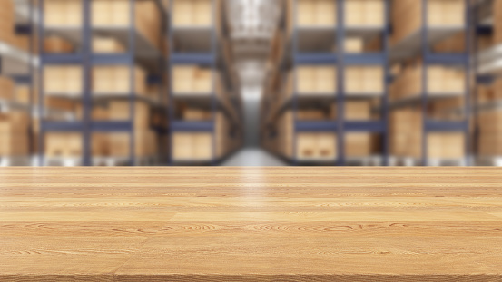 Focus on Wooden Table Top with a Blurred Warehouse Full of Boxes. 3D Render