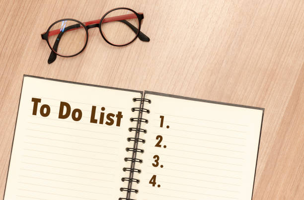 istock Top view notebook write message To Do List and number list with glasses on table 1409840824