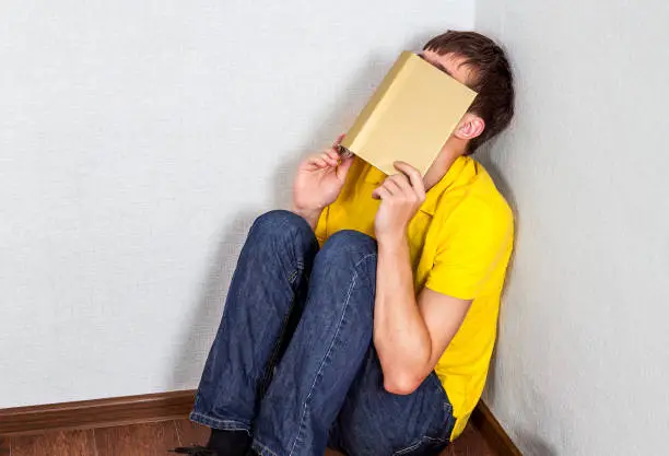 Student with a Books feel a Stress in the Corner of the Room