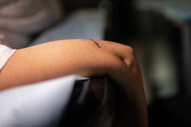 istock Young woman resting her arm after getting a new tattoo 1409844904