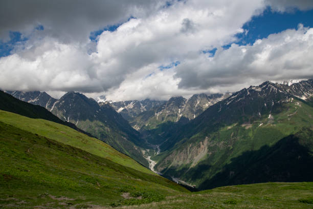 istock Beautiful mountains landscape. Panoramic view on the green hills and mountains under clouds . 1409846296