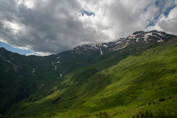 Beautiful mountains landscape. Panoramic view on the green hills and mountains under clouds .
