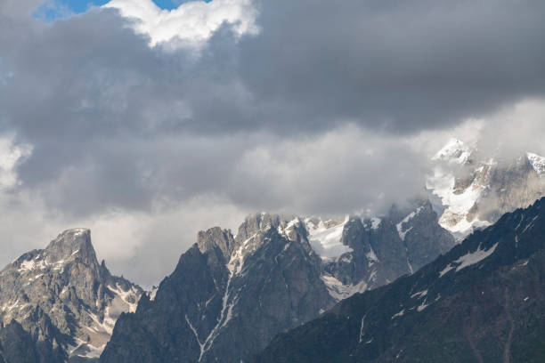 istock Clouds over the mountains. Amazing high rocks in the fog. 1409846485