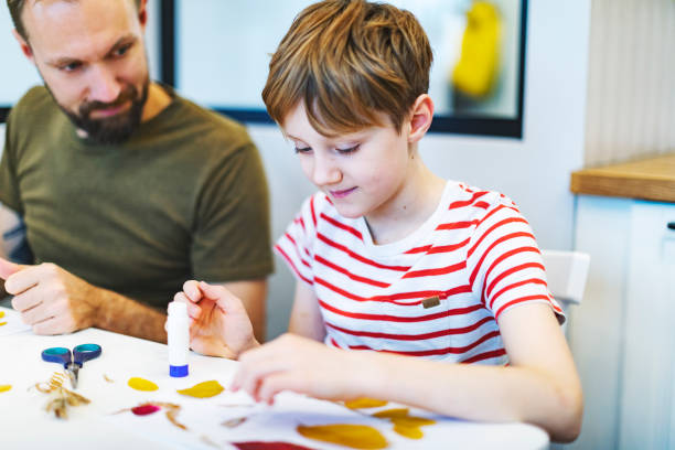 istock Father helping son with homework for school 1409846516