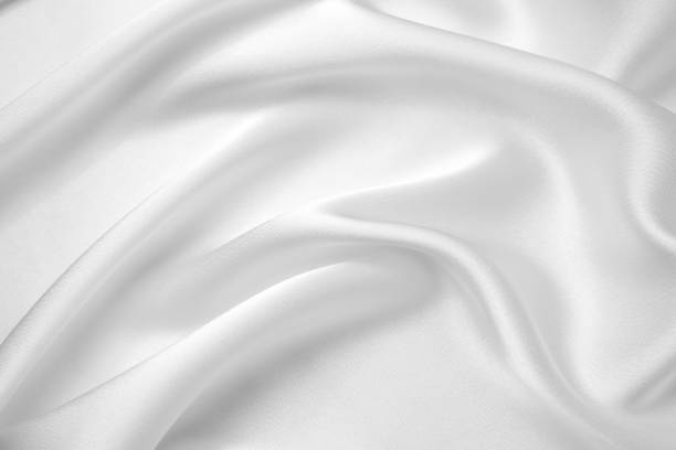 istock Smooth elegant white silk or satin luxury cloth texture can use as wedding background. Luxurious background design. 1409846698