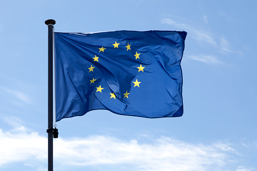 Flag of the European Union waving un mid air.