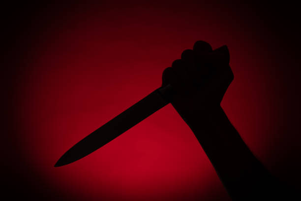 istock Hand with a knife silhouette behind a curtain. Halloween 1409850712