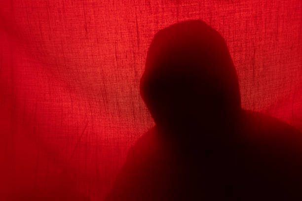 istock Hand with a knife silhouette behind a curtain. Halloween 1409850769
