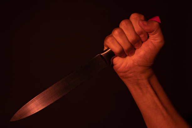 istock Hand with a knife silhouette behind a curtain. Halloween 1409850975