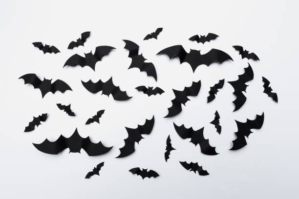 istock halloween and decoration concept - paper bats flying 1409851031