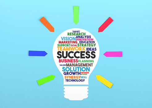 Paper in the shape of a lightbulb and the words Success on it. Blue background and colorful sticky note papers.