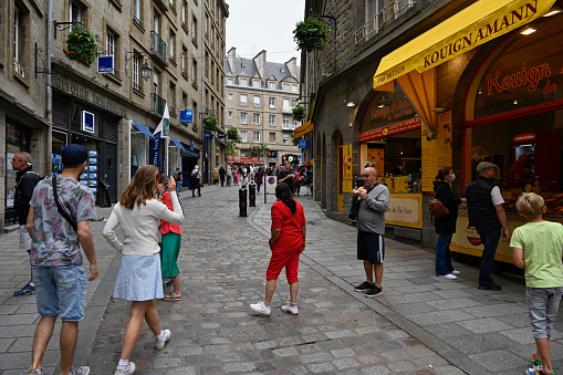 Saint-Malo, France, July 7, 2022 - Tourists on Rue Porcon de la Barbinais in the old town of Saint-Malo / Intra Muros, Brittany