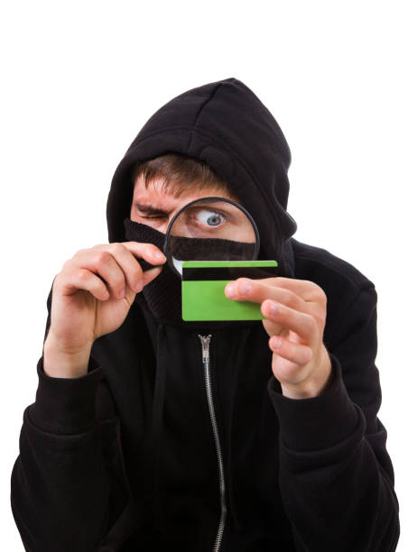 hacker with a bank card - snooper imagens e fotografias de stock