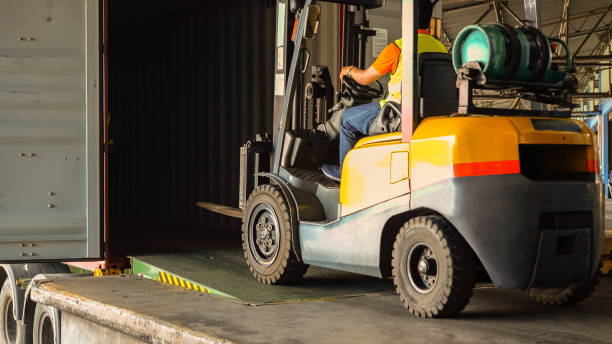 istock Warehouse worker start loading delivery truck with cardboard boxes in warehouse storage, Product distribution logistics center, Working in delivery, Warehouse working concept 1409854156