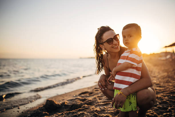 istock Mother and son on the beach during the sunset 1409855901