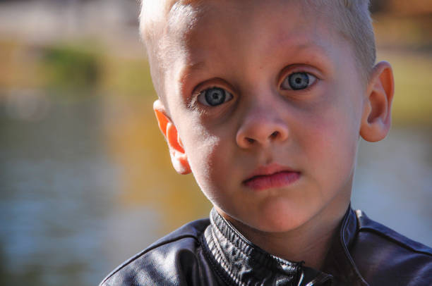 Little boy looking up at camera