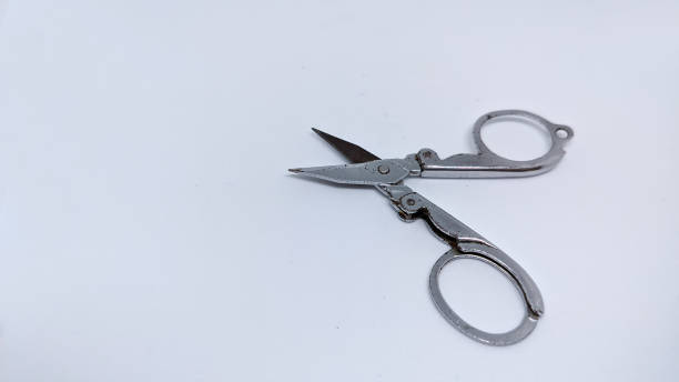 istock Scissors in silver on a white background shot at a 45 degree angle 1409857709