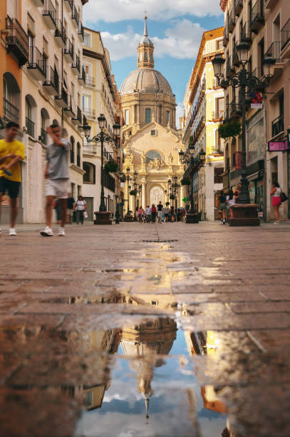istock Street in Zaragoza and reflection 1409858650