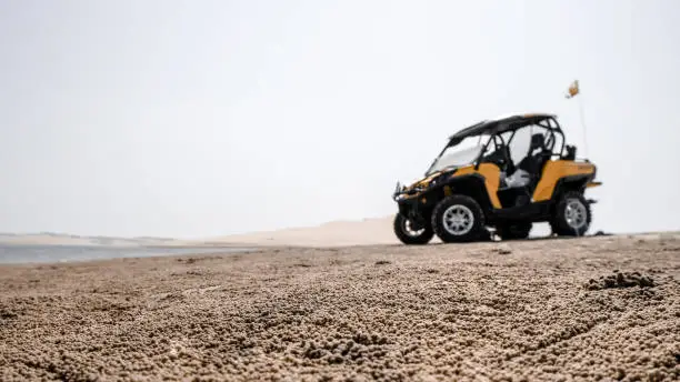 Photo of Blurred silhouette of buggy car un the desert in Qatar