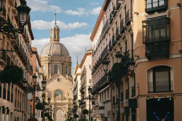 A street in Zaragoza with El Pilar basilica in the background