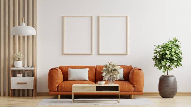 istock Mock up poster frame in modern interior with leather sofa and accessories in the room. 1409860516