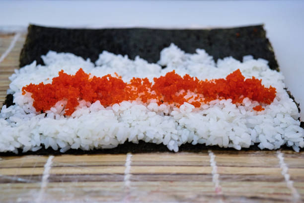 Cooking rice rolls and sea urchin caviar stock photo
