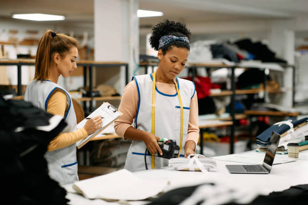istock African American female worker labelling fabric while working at textile workshop. 1409863361