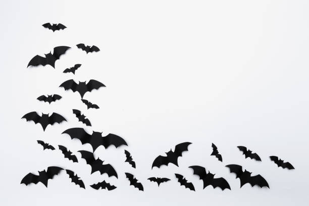 istock halloween and decoration concept - paper bats flying 1409865094