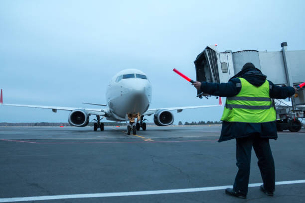 istock Aircraft marshalling at the aiport apron 1409865815