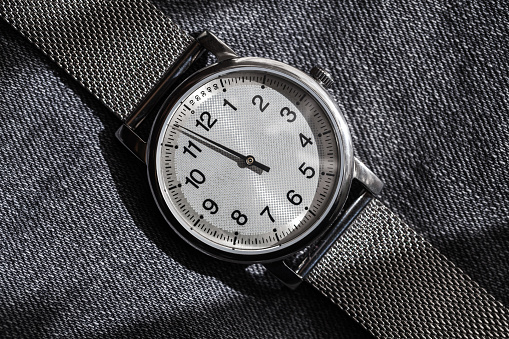 One hand automatic mechanical wrist watch in stainless steel case. Closeup photo