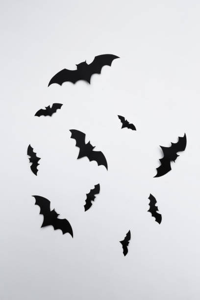 istock halloween and decoration concept - paper bats flying 1409866142