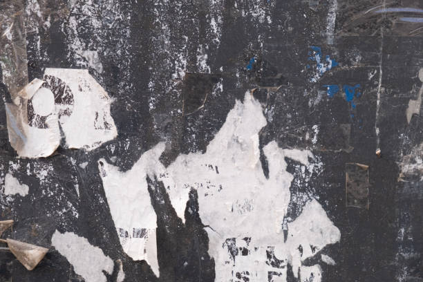 istock Torn street poster on a black background. Grungy abstract background 1409866298