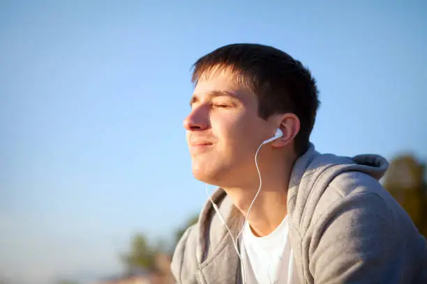 Young Man listen to the Music outdoor