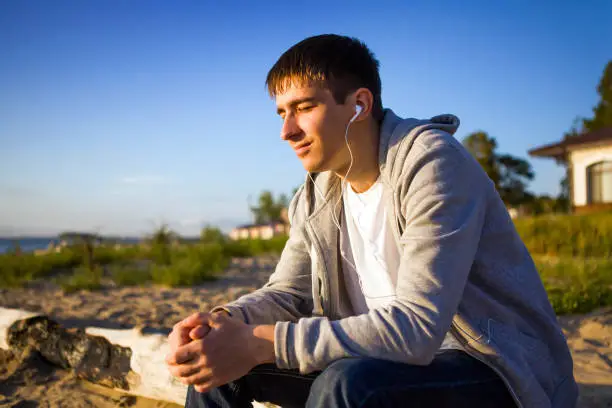 Happy Young Man listen to the Music outdoor