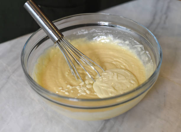istock Egg beater in a glass bowl  mixing dough 1409869183