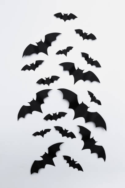 istock halloween and decoration concept - paper bats flying 1409873178