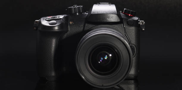 istock Closeup of professional camera with black background 1409873384