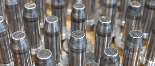 Full frame shot of group of steel pins waiting for further processing in workshop. Industrial background.