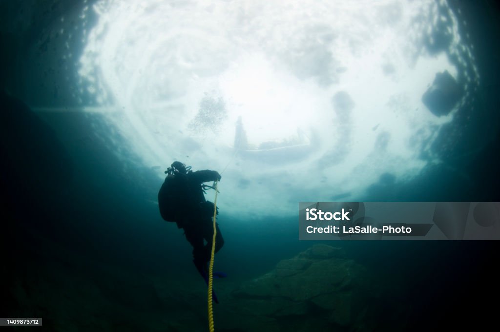 Underwater ice diving Winter ice diving underwater in a quarry in Canada Scuba Diving Stock Photo
