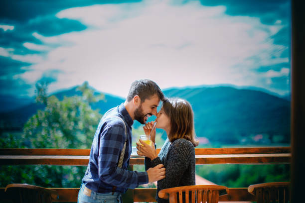 Young couple enjoying on the mountain during summer morning.