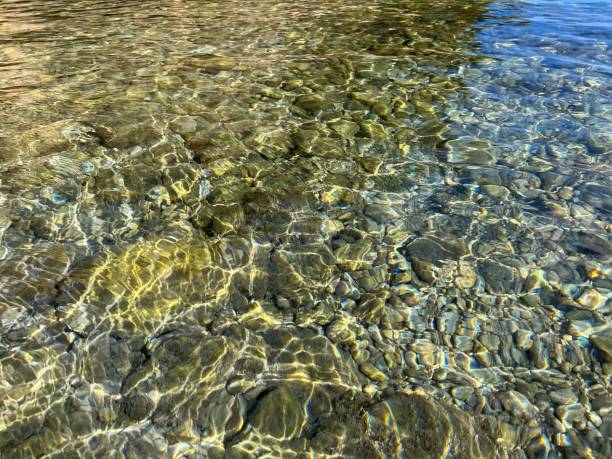 istock Clear sea water with pebbles and stones at the bottom. 1409874689