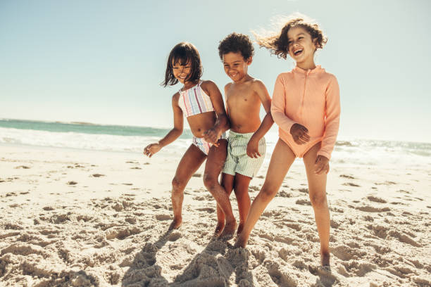 istock Cheerful children having fun at the beach 1409875695