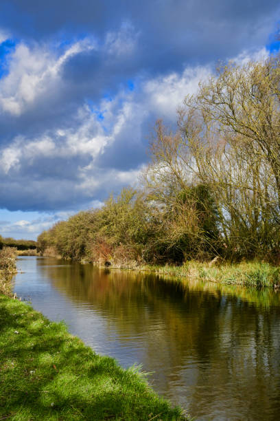 istock Slow flowing river , canal in winter, moody sky 1409876351